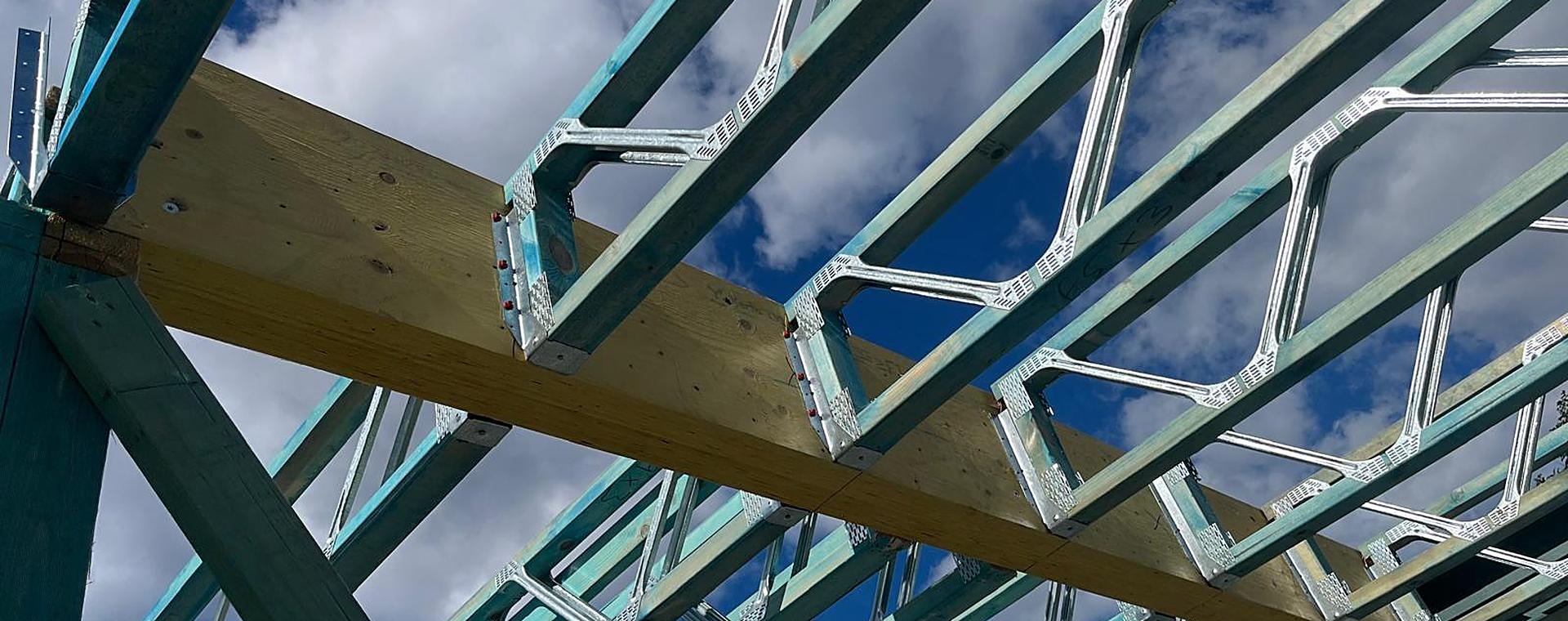 Floor trusses with steel webs hung from an LVL beam