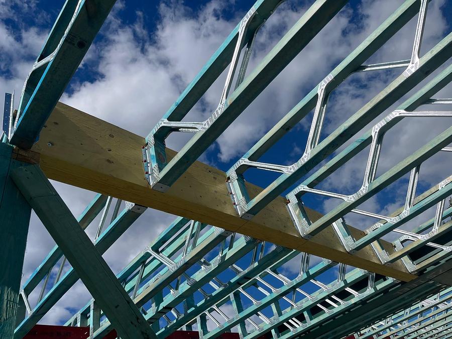 Floor trusses with steel webs hung from an LVL beam